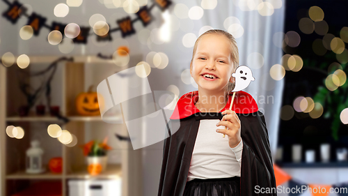 Image of girl in costume of dracula with cape on halloween