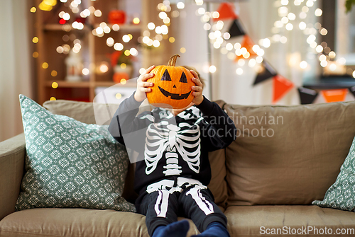 Image of boy in halloween costume with jack-o-lantern