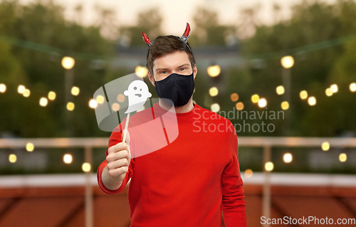 Image of man in halloween costume of devil and mask