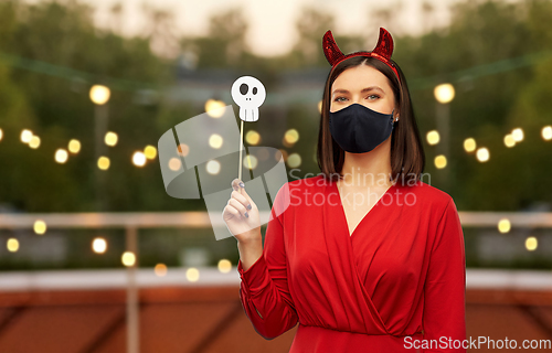 Image of woman in halloween costume of devil and black mask
