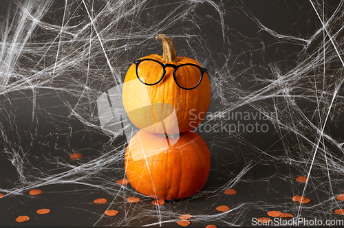 Image of halloween pumpkins with glasses and spiderweb