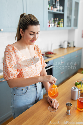 Image of woman making cocktail drinks at home kitchen