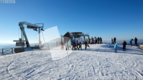 Image of A lot of people skiing on a ski slope with a t-bar