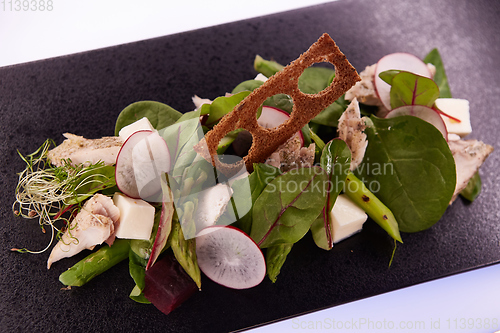 Image of Green salad with radish and croutons. Shallow dof