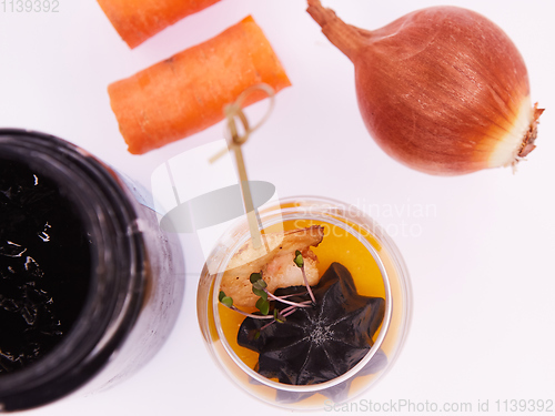 Image of Appetizer in a glass. Shrimp with vegetable puree with cuttlefish ink. Healthy food. Top view