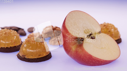 Image of Fruit jelly with fresh apple. Healthy food. Apple jelly on chocolate with walnuts. Summer dessert with fruit jelly