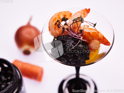 Image of Appetizer in a glass. Shrimp with vegetable puree with cuttlefish ink. Healthy food. Top view