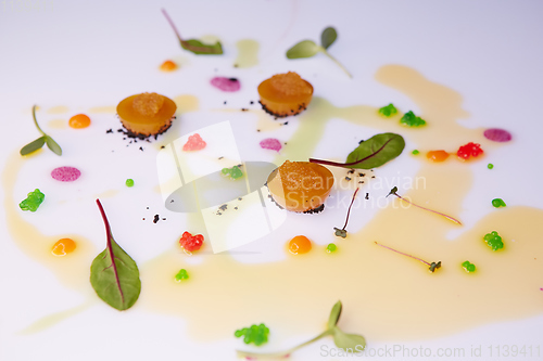 Image of vegetable jelly with pike caviar dressing with sauce and green leaves