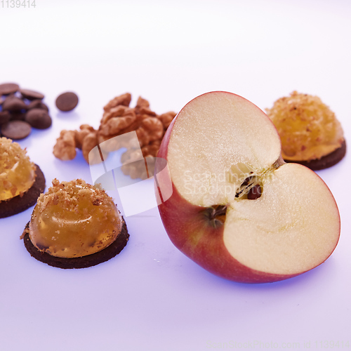 Image of Fruit jelly with fresh apple. Healthy food. Apple jelly on chocolate with walnuts. Summer dessert with fruit jelly