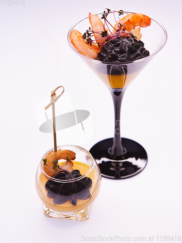 Image of Appetizer in a glass. Shrimp with vegetable puree with cuttlefish ink. Healthy food. Top view