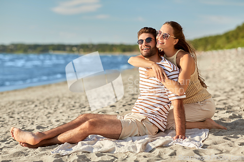 Image of happy couple hugging on summer beach