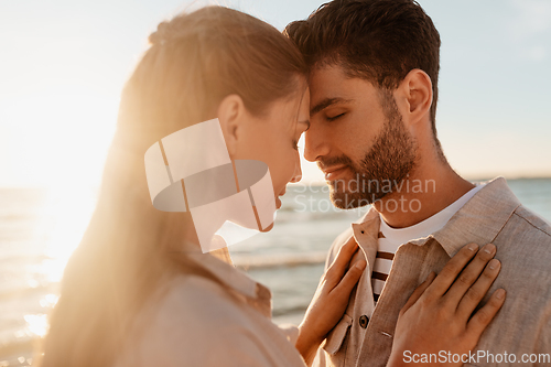 Image of happy couple with closed eyes on summer beach