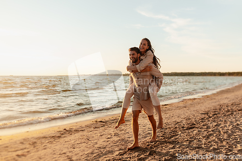 Image of happy couple having fun on summer beach