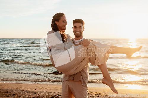 Image of happy couple having fun on summer beach