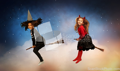 Image of girl in black witch hat with broom on halloween