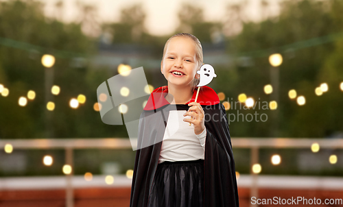 Image of girl in costume of dracula with cape on halloween