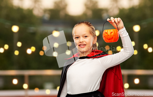 Image of girl in halloween costume of dracula with pumpkin