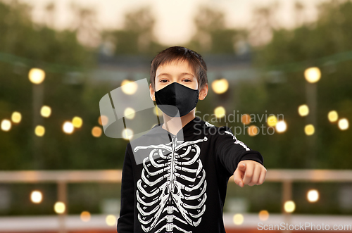 Image of boy in mask and halloween costume of skeleton