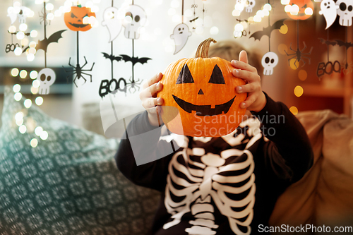 Image of boy in halloween costume with jack-o-lantern
