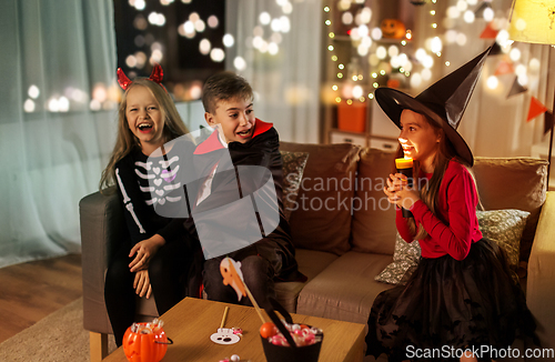 Image of kids in halloween costumes playing at home