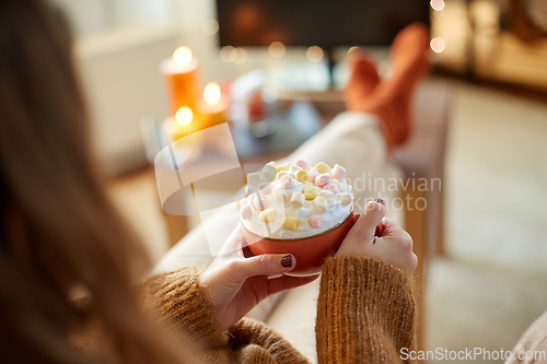 Image of woman with cream and marshmallow on halloween