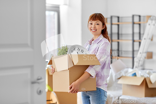 Image of happy woman unpacking boxes and moving to new home