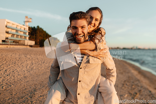 Image of happy couple having fun on summer beach