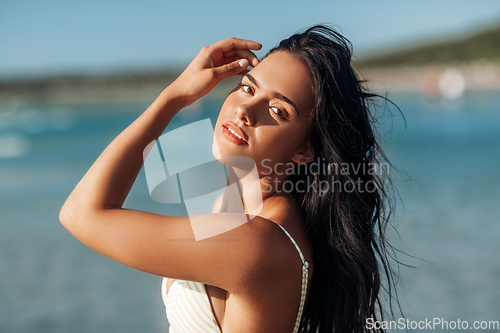 Image of beautiful young woman in bikini swimsuit on beach