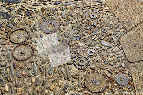Image of Floor with pattern from pebbles and rusty metal details