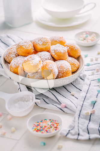 Image of Cottage cheese donuts balls with sugar in a bowl. Healthy curd dessert.