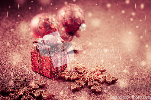 Image of Christmas Present with ornaments and balls. Blurry glitter  background.