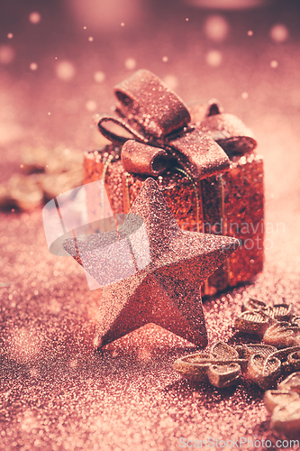 Image of Christmas Present with ornaments and balls. Blurry glitter  background.