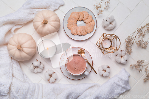 Image of Hot chocolate and cocoa, autumn and winter still life with candle, cookie and book