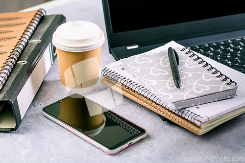 Image of Modern office desk table with laptop, smartphone and other supplies with cup of coffee