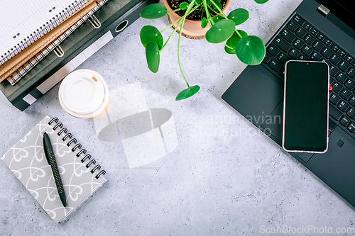 Image of Modern office desk table with laptop, smartphone and other supplies with cup of coffee