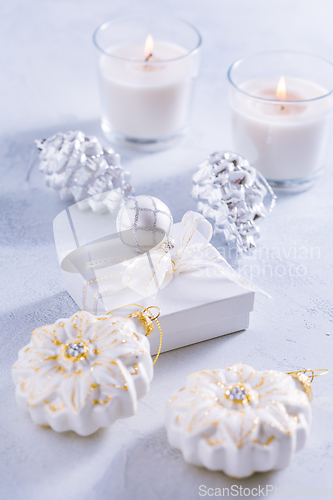 Image of Christmas ornaments in snowy white. 