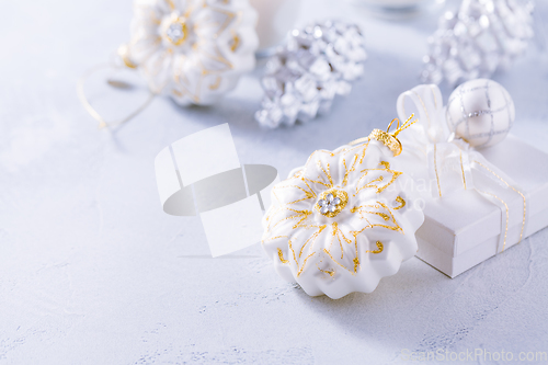 Image of Christmas ornaments in snowy white. 