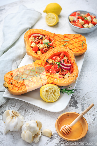 Image of Halved roasted butternut squash with spicy vegetable filling and