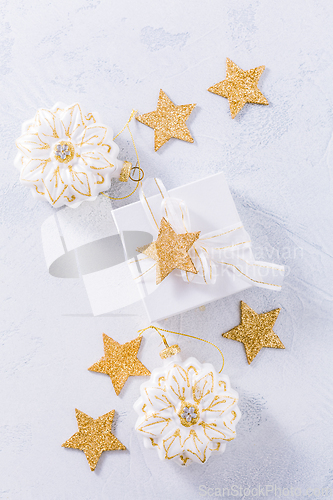 Image of Christmas gift with ornaments in white.