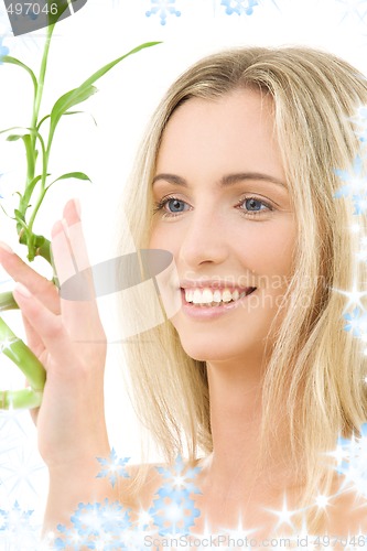 Image of happy blonde with bamboo