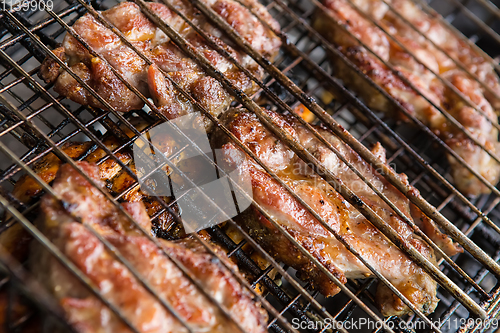 Image of pieces meat char-grilled over flame