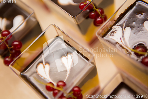 Image of Layered dessert with fruits, nuts and cream cheese in glass jar