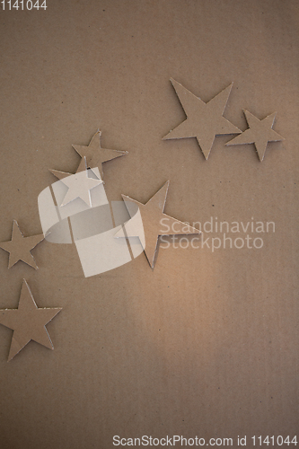 Image of Cardboard stars on a brown background. Eco-style