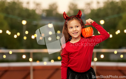 Image of girl in halloween costume with jack-o-lantern