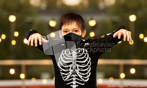 Image of boy in mask and halloween costume of skeleton