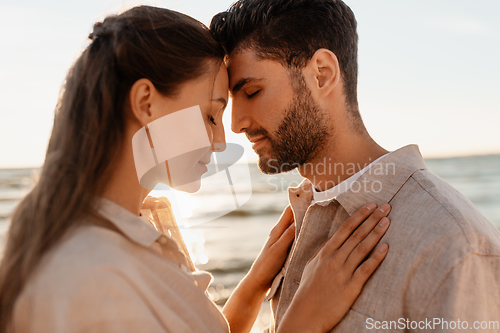 Image of happy couple with closed eyes on summer beach