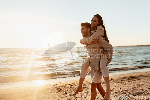 Image of happy couple having fun on summer beach