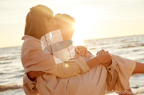 Image of happy couple having fun on summer beach