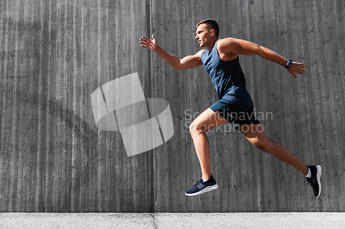 Image of young man running outdoors