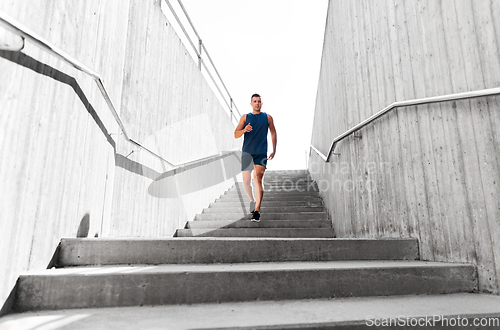 Image of young man running downstairs